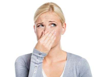 Woman holding nose